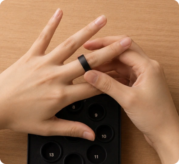 Trying an Actxa Core Smart Ring sizing sample on a finger