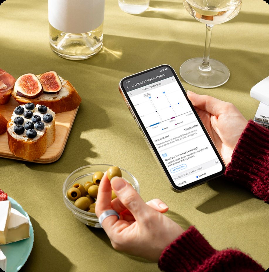 Person wearing the Core Smart Ring while viewing an AI Glucose Scan result