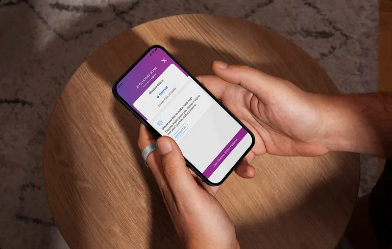 Person wearing an ACTXA smart ring while using the ACTXA app on a phone